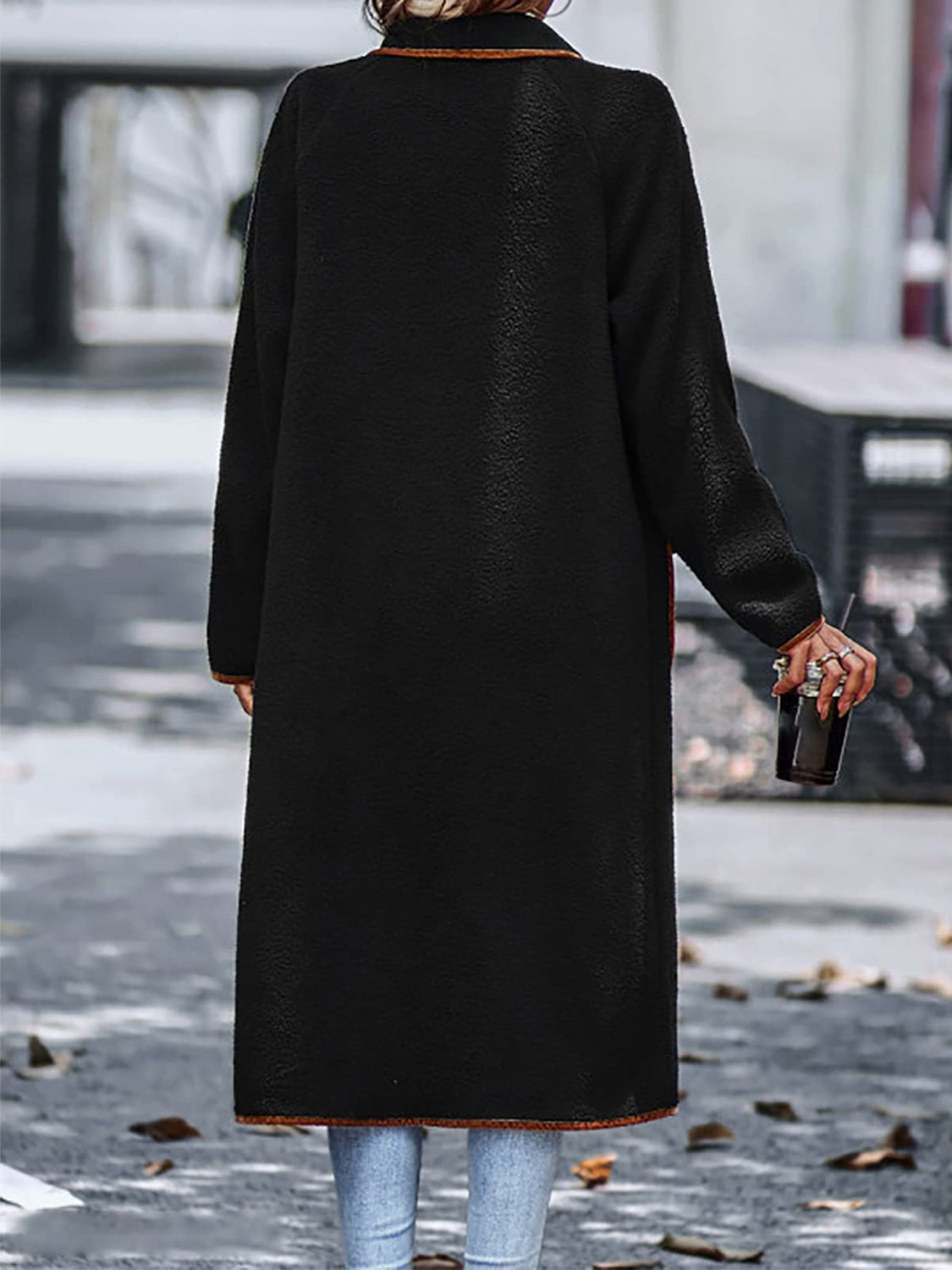 Full-length contrast trim wool coat with pockets, worn on a city street during autumn