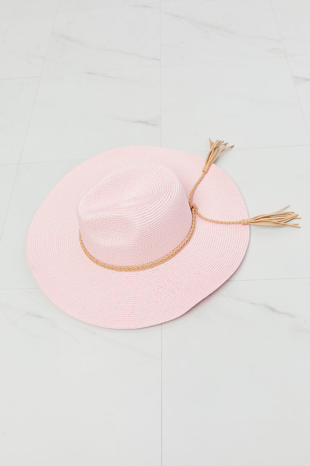 Elegant pink straw hat with natural fiber details