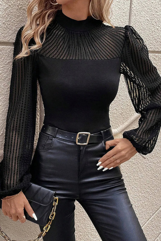 Stylish black mock neck long sleeve blouse with pleated balloon sleeves against a neutral background.