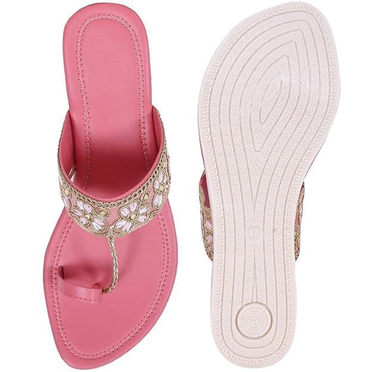 Decorative pink and gold women's sandals with ethnic embroidery and a flip-flop style design on a white background.