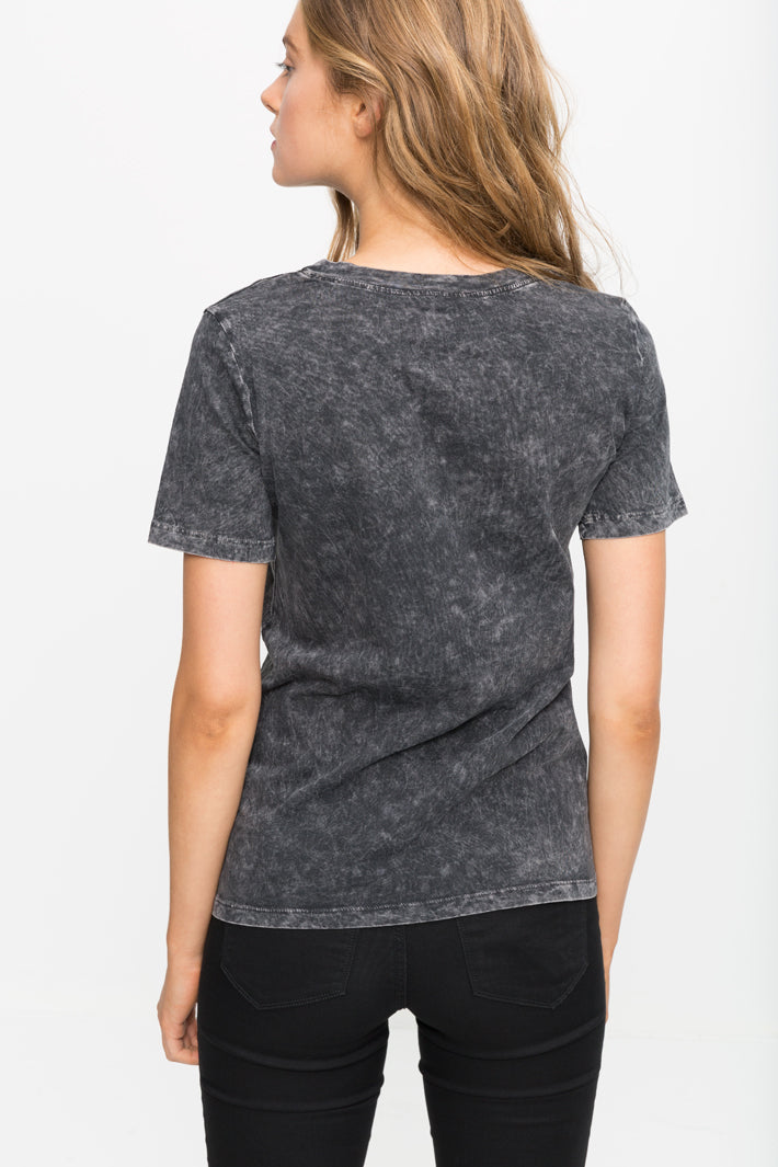 Stylish mineral-washed grey t-shirt with sheer details, showcased on a female model with long blonde hair.